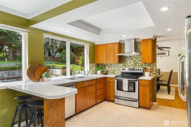 Spacious & functional kitchen with SS appliances, glass tile, and walk in pantry.