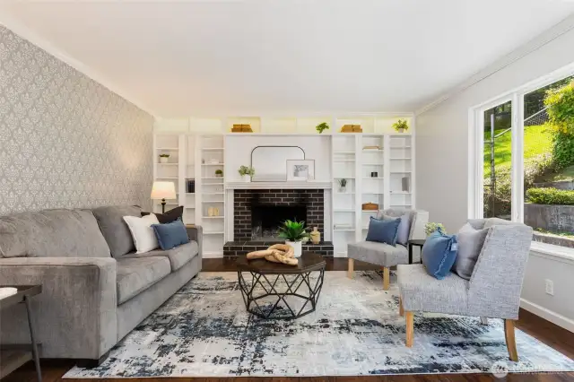 Family room with cozy wood burning fireplace & built-ins.