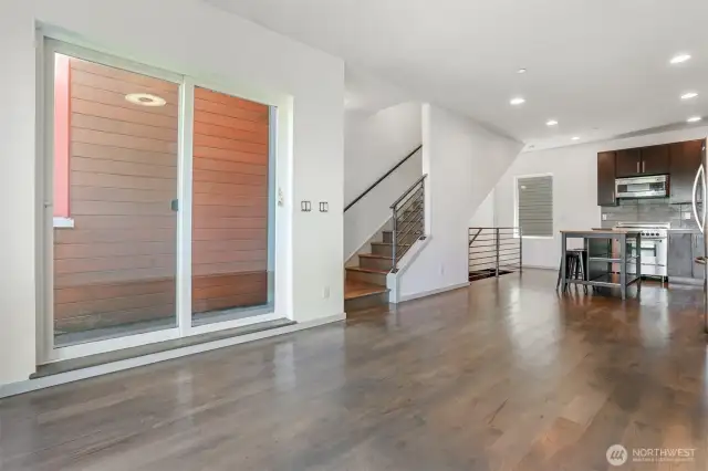 View from living room looking at slider to BBQ patio & stairs to 4th floor.