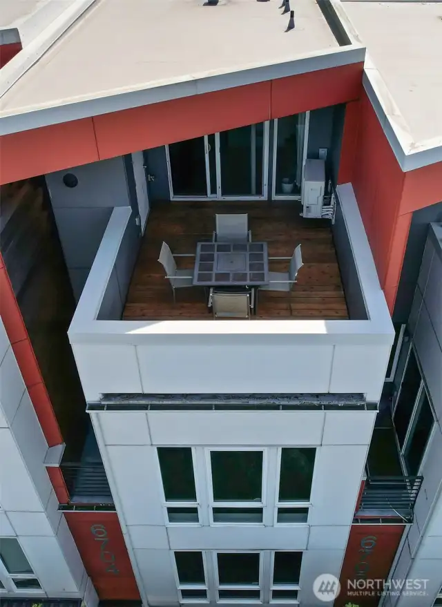 Partially covered roof top patio plumbed with natural gas and extra storage.