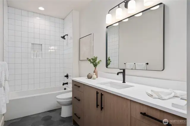 Full bath with quartz and tile floors