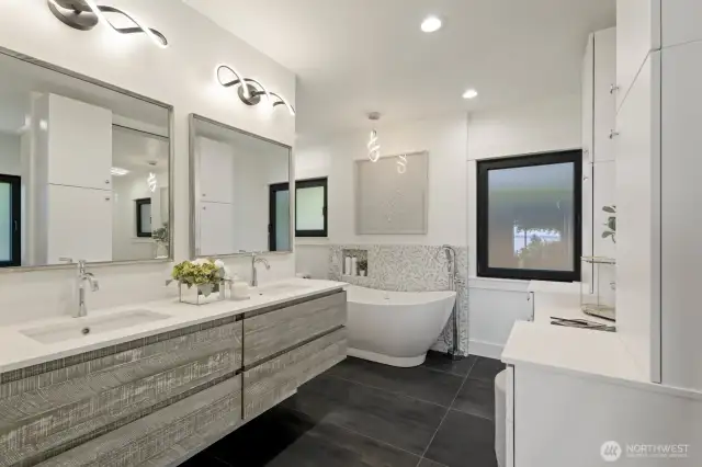 Primary ensuite with floating vanities, heated floors, free standing tub, walk-in closed and built in safe.