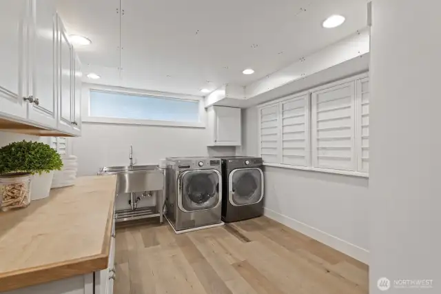 Laundry room with lots of storage and fold out drying racks.