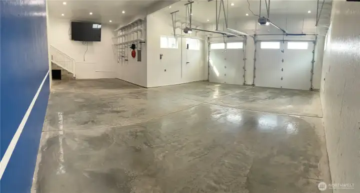 Garage parking area 23' wide 28'8" deep. Extra storage area 14'x13'. Comes with 78" TV for potential "person" cave!