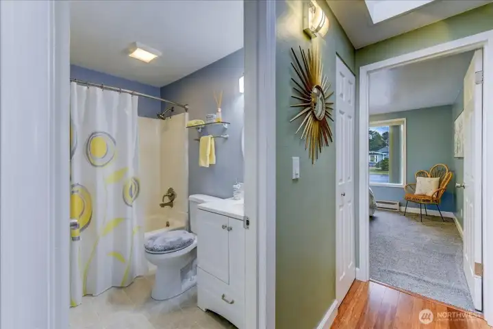 Main bath with tub and shower off the hallway
