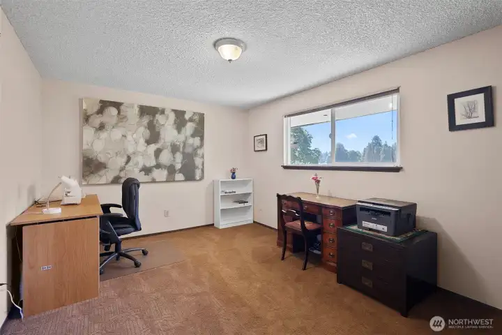 One of two good-sized additional bedrooms, this one is currently in use as office and sewing room.