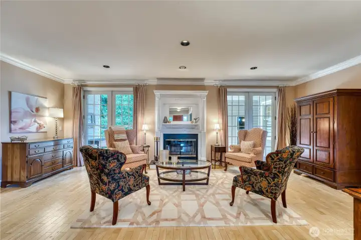 Living/great room showing fireplace and double doors leading to entertainment deck.