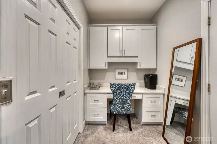 Builtin desk/office next to walk-in closet attached to private guest quarters.