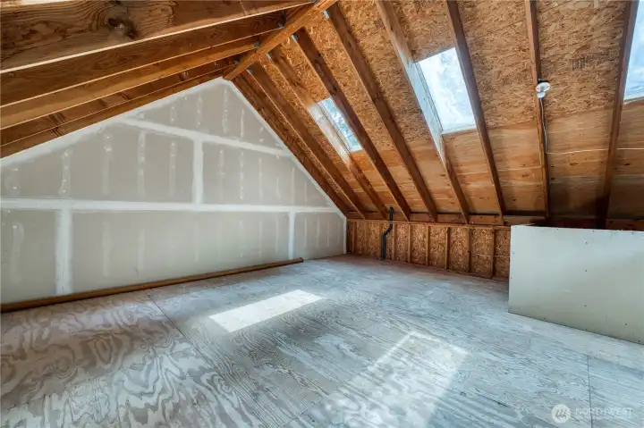 Unfinished upper level garage workspace or storage.