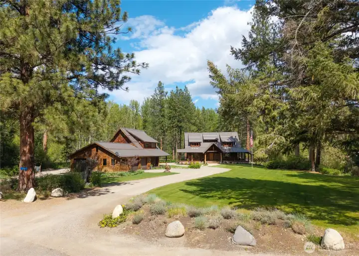 Versatile compound featuring the main home, detached 4-car garage with workshop, and guest quarters above—complete with bunk room, two bathrooms, and a dedicated gear room for year-round recreation and hosting