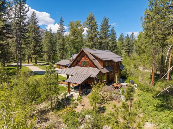 Northwest contemporary design with warm log accents, inviting covered porch, private hot tub, and expansive decks—thoughtfully designed for comfort, quality, and year-round enjoyment in a serene, private setting