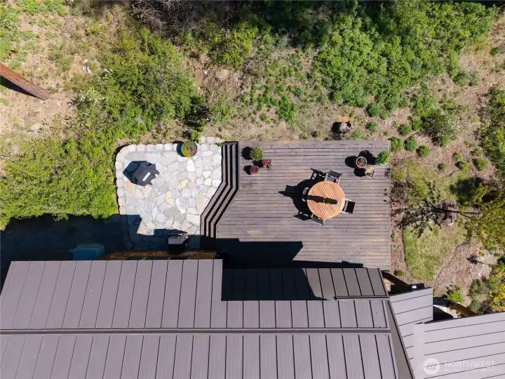 Private outdoor living from above—expansive deck and stone patio create an inviting space for dining, relaxing, and taking in the peaceful natural surroundings