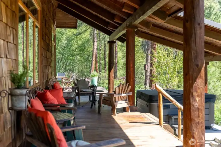 Outdoor living spaces designed for relaxation and entertaining—expansive deck and stone patio immersed in a peaceful natural setting