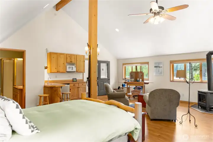 Private guest house suite offering a bright, open layout with vaulted ceilings, warm wood accents, and comfortable living space—ideal for extended stays, guests, or flexible use
