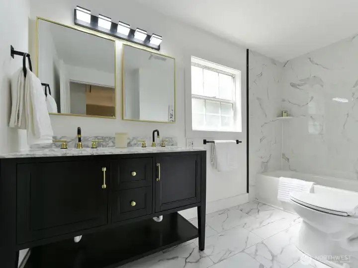 Bathrooom one beautifully remodeled bathroom that is  a testament to thoughtful design, showcasing elegant fixtures