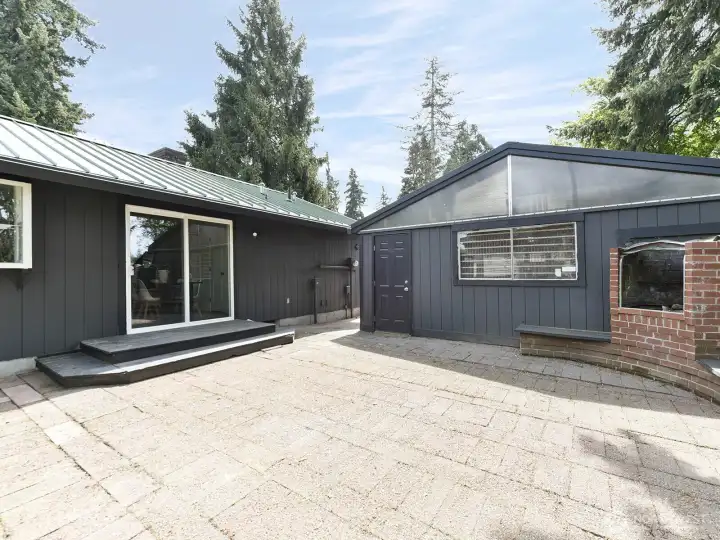 Back of home with patio and backside of garage