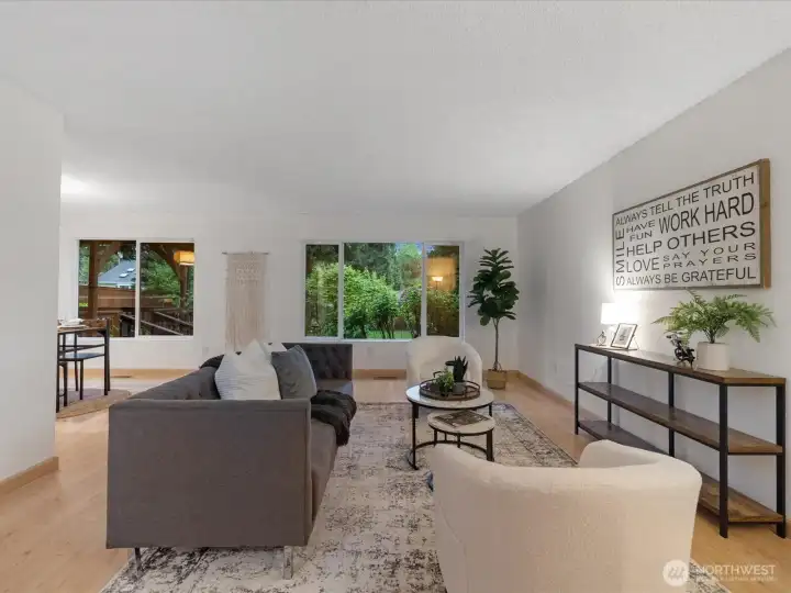 Spacious living room as you walk in front door with large windows to bring in lots of natural light.