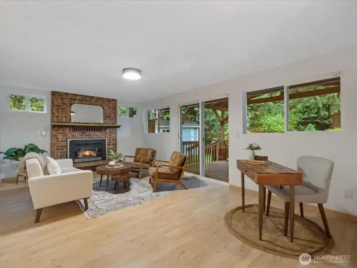 Gas fireplace in this family room right off the kitchen with glass slider leading out large covered back deck.