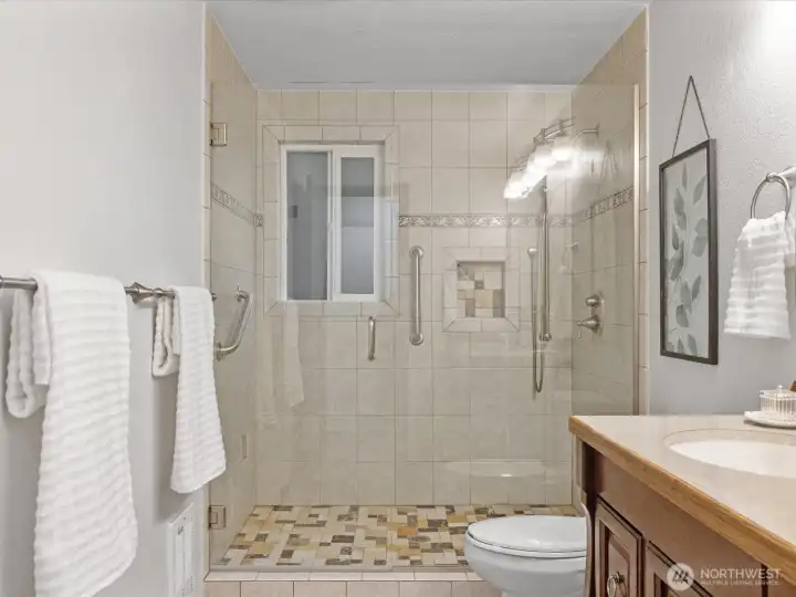 Primary bathroom with full tile shower & window that open for ventilation.