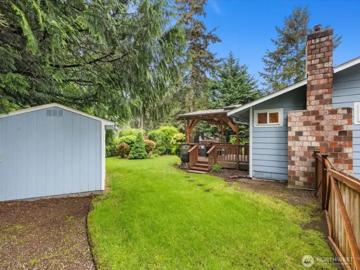 Backyard view with outbuilding to store yard tools.