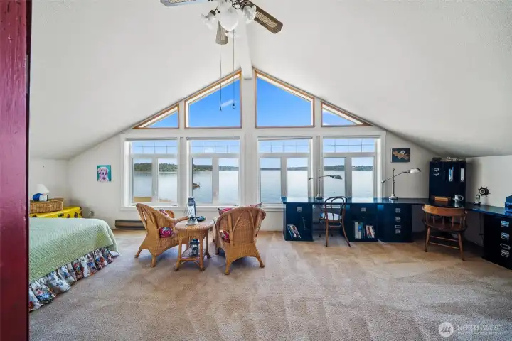 Upstairs finds this stunning bank of windows to the Sound. Use this as a primary with a view, or stack 'em high with bunkbeds for maximum grandkid storage