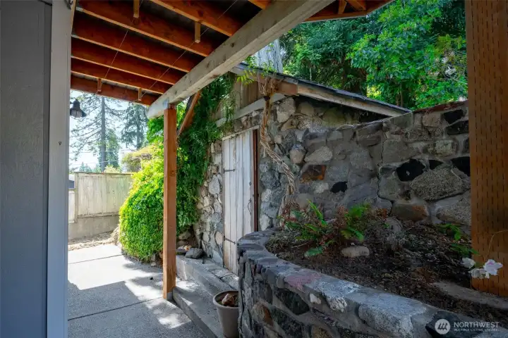 One of the examples of the beautiful stonework on this property. This is the well house and storage area on the main level, under the upper floor balcony