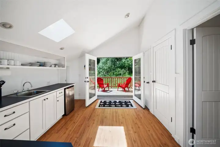 The apartment upstairs has so much to offer! Let's start with the welcoming french doors with a deck looking to the woods and apple tree