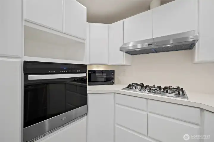 Built in oven, nice cooktop & fan. There is a large cabinet to the left of the oven with pull-out shelving!