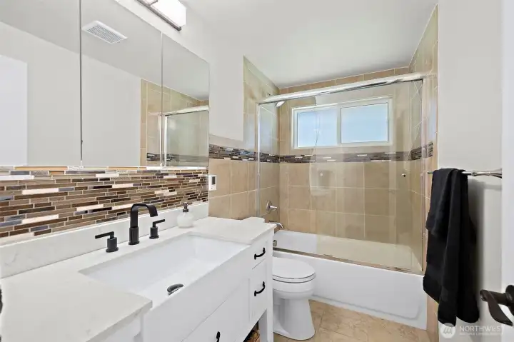 This bath is amazing offering heated floors, custom tiled surround, granite counter & backsplash, gorgeous sink and hardware! Don't miss the unique curved shower door slider!