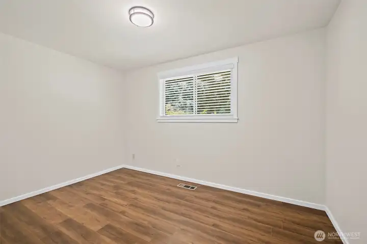 One of 3 bedrooms, this one faces the back of the home.