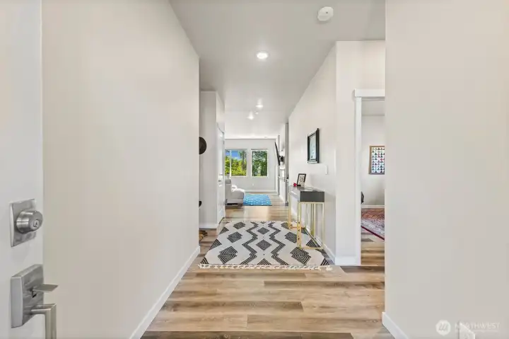 Entry hallway into the home. Two of the bedrooms and a full bathroom are to the right.