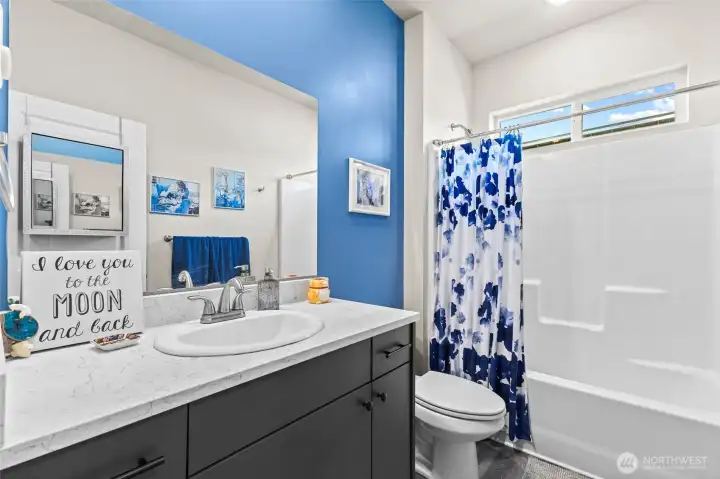 Full bathroom to the right of the entry hallway.