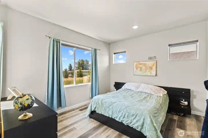 Primary bedroom with plenty of windows for natural light.