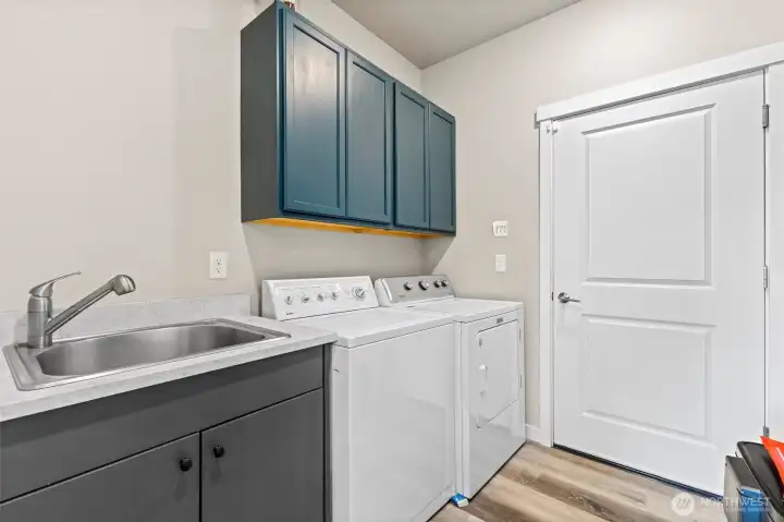 Laundry room with door to the garage.
