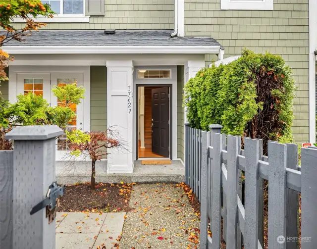 Gate opens to a cute courtyard leading to front door