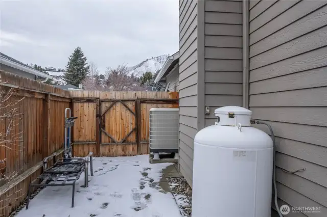 side yard by garage, propane tank for great room fireplace