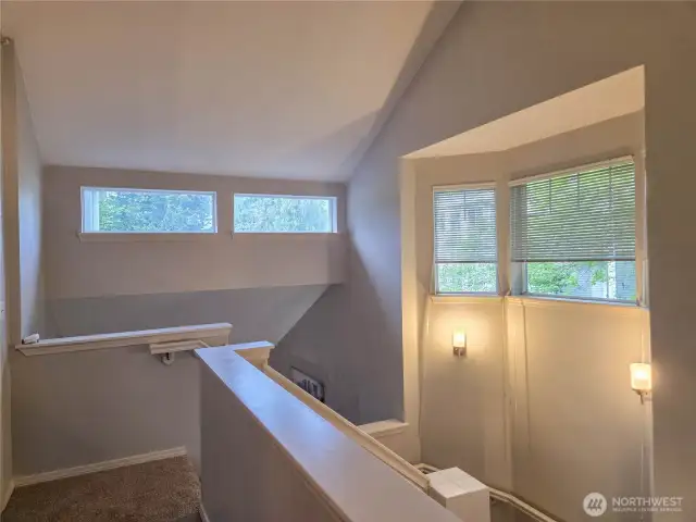 This is the stairway and upper level hallway.  The high ceilings and windows provide lots of light.
