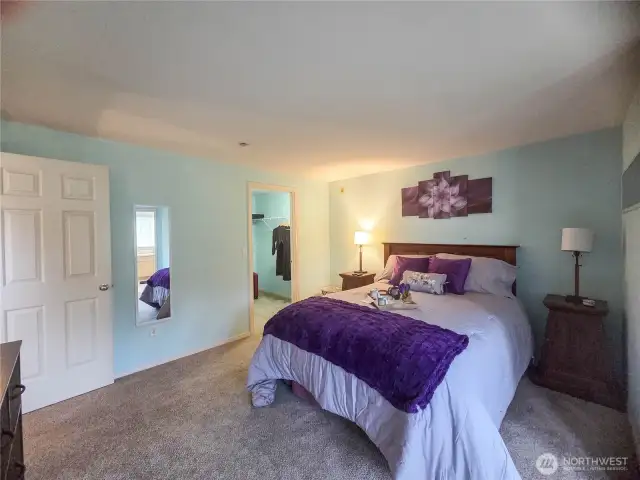 At the top of the stairs is the door to the primary ensuite with a large walk-in closet.