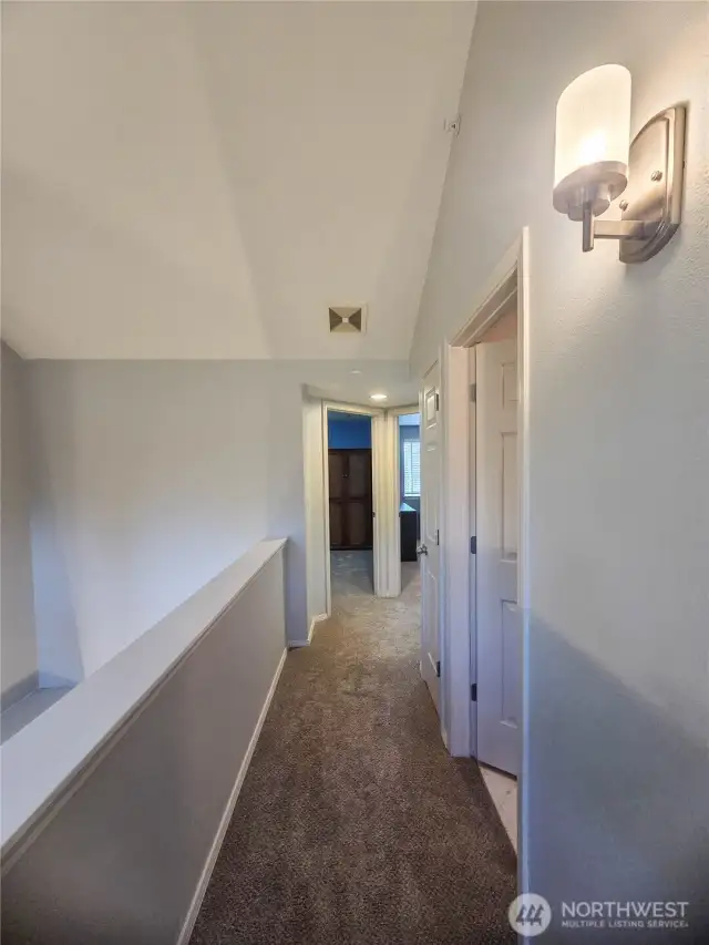 Upstairs hallway leads to all bedrooms, laundry room and full main bathroom.