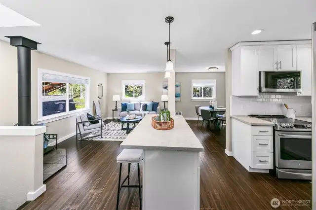 Open living space; great light- newer finishes, plus access to a covered deck. Notice the cozy gas fireplace.