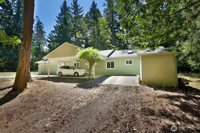 Carport in front of house for easy drop off and weather protection in addition to the oversize garage.