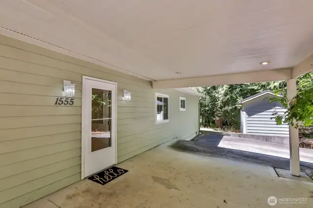 Covered carport area leads to front door entry.