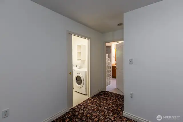 View from primary bedroom showing entry to laundry room and to primary bath.