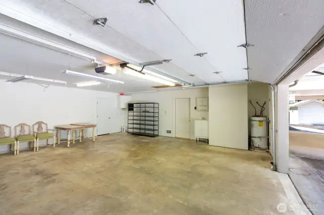 Garage interior. Door leads to kitchen area. Hot water heater located in garage.