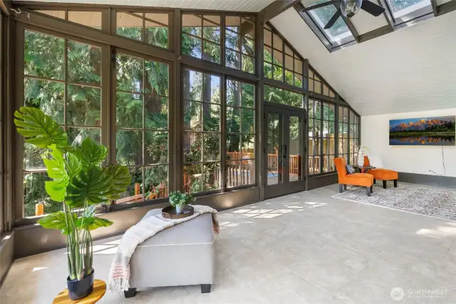 Solarium has ceramic tile floors, 4 skylights and two walls of windows.  Step out through the French doors to the secluded deck.