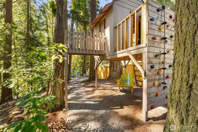 This unique treehouse with climbing wall was built by a professional contractor.  Hours of fun and memories to be made here!