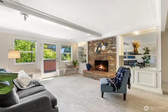 Beautiful bonus room on the lower level features a wood-burning fireplace and access to the hot tub!