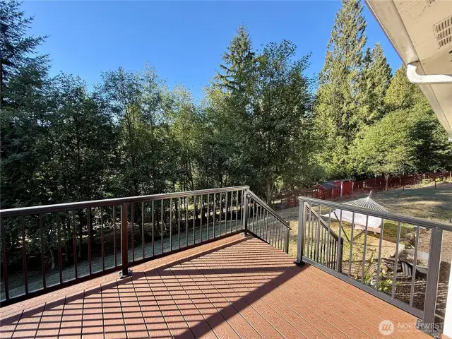 Front deck with access to outbuildings, fenced in areas for animals and the fruit tree orchard