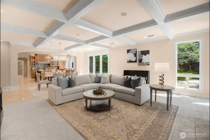 looking from family room with boxed ceiling to the kitchen