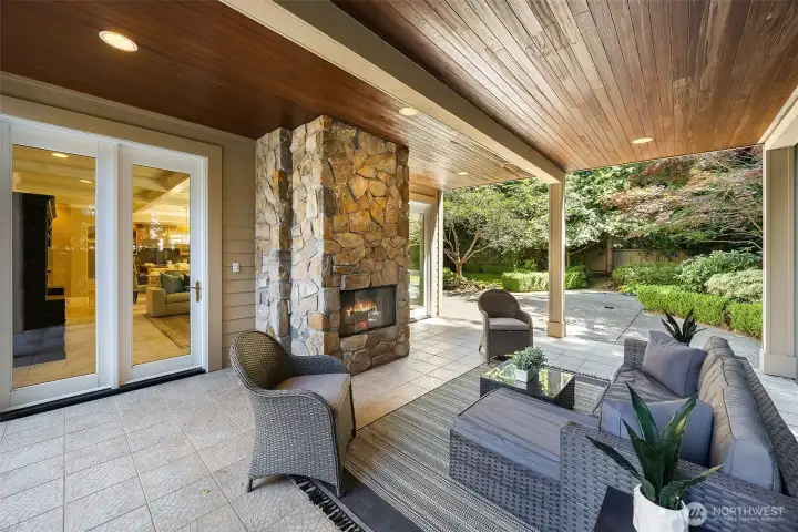 covered patio with wood burning fireplace